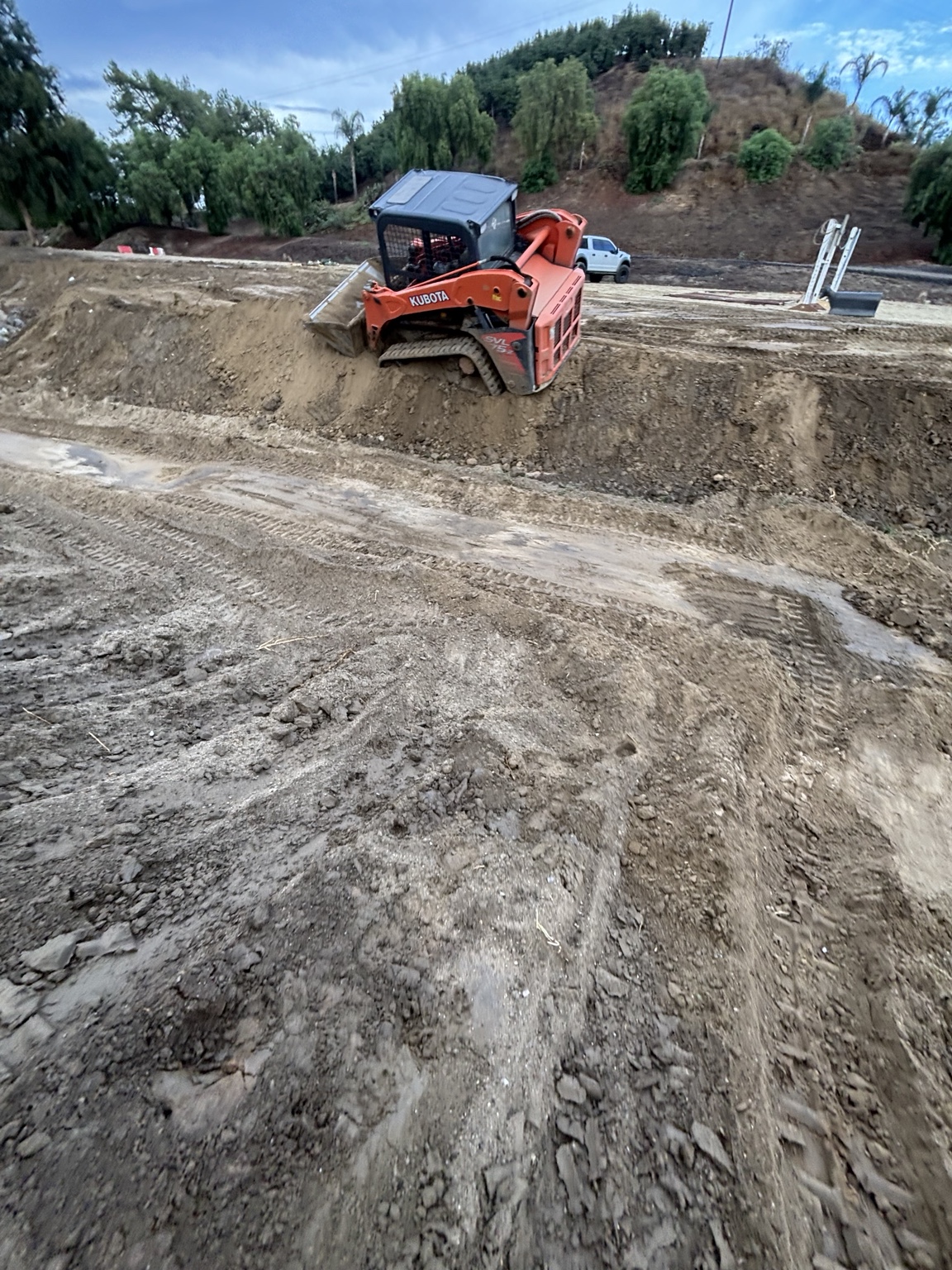 Kubota track loader grading a soil site