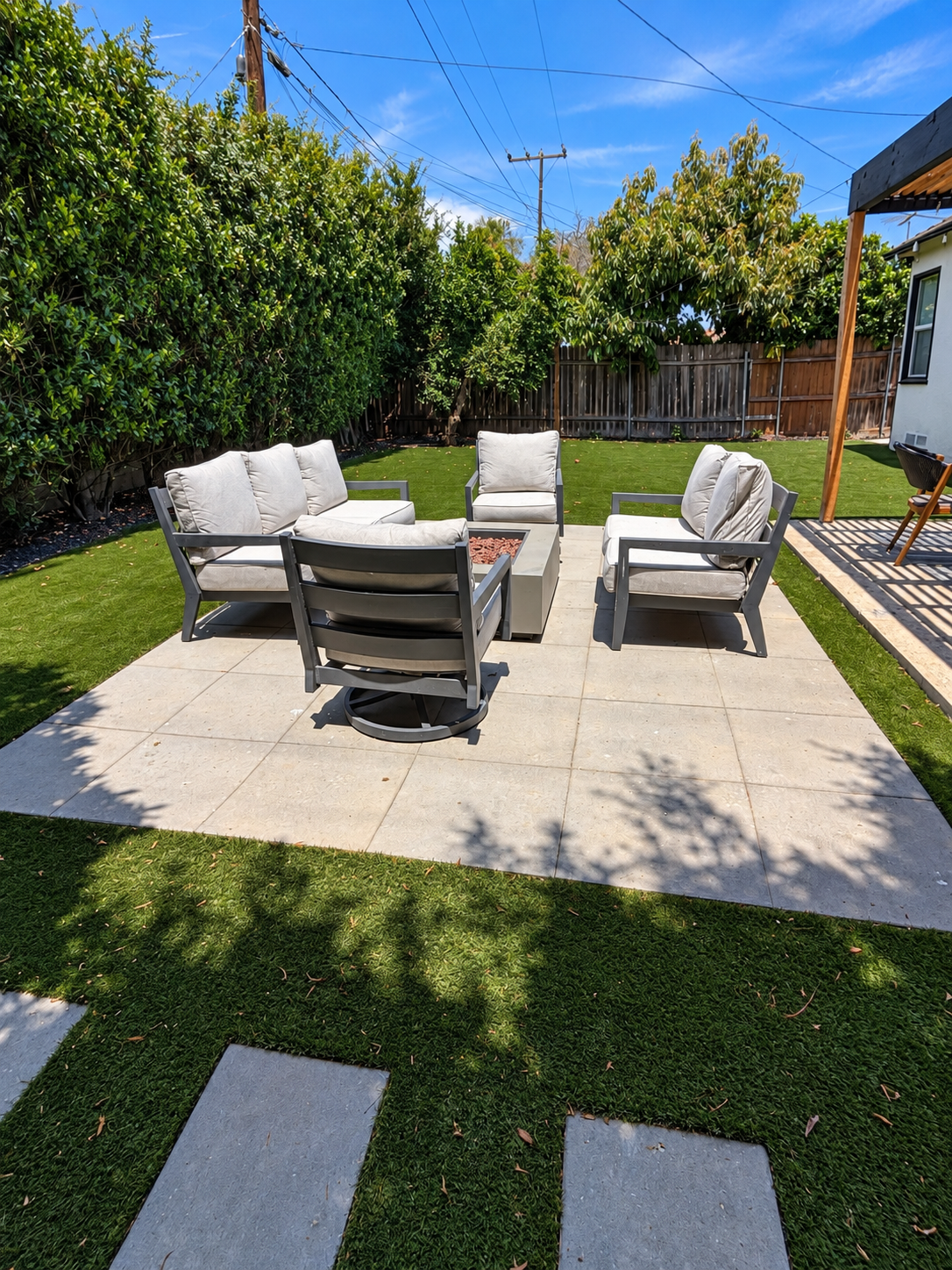 Paver seating area surrounded by artificial turf